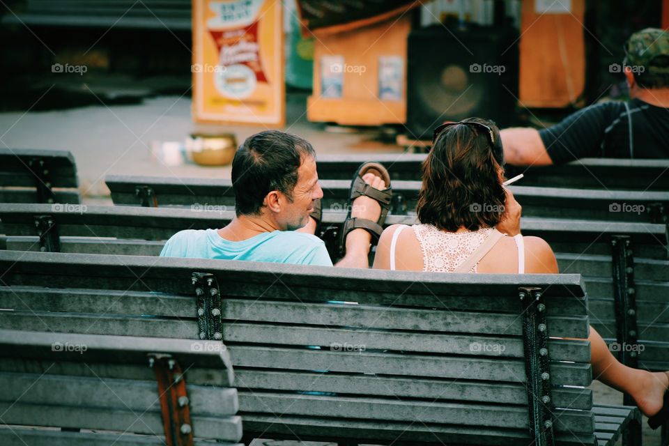 couple sitting in city open theatre park 