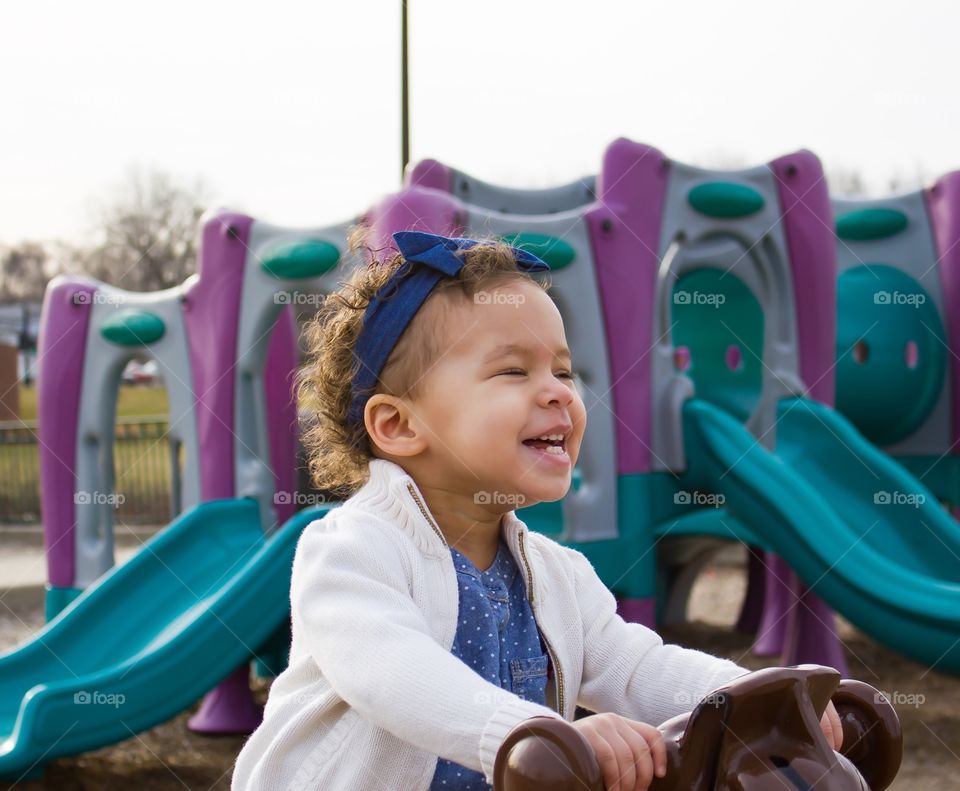 Girl enjoying at playground near slide