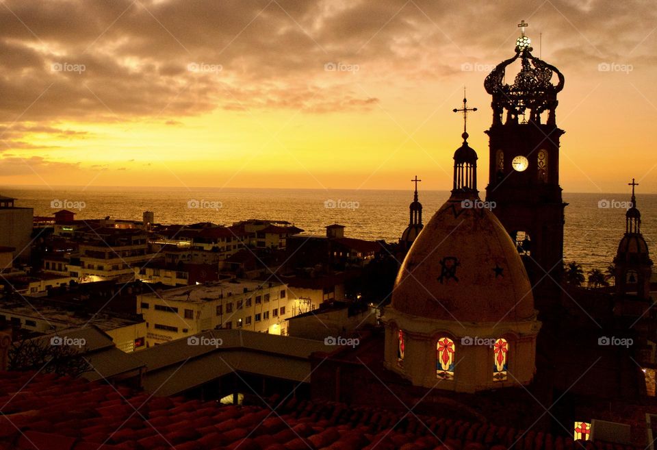 Sunset over Puerto Vallarta with the Church of Our Lady of Guadalupe, known locally as the Iglesia de Nuestra Señora de Guadalupe in the foreground.