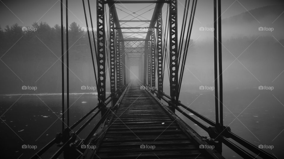 Empty bridge in foggy morning