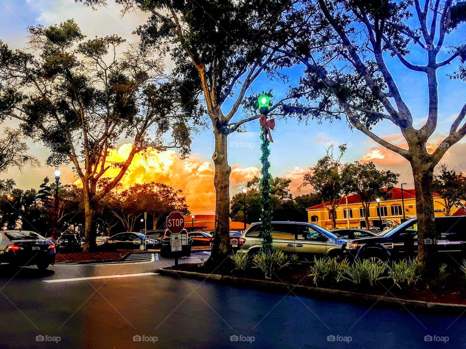 beautiful sky with huge sunlit clouds and reflections over parking lot
