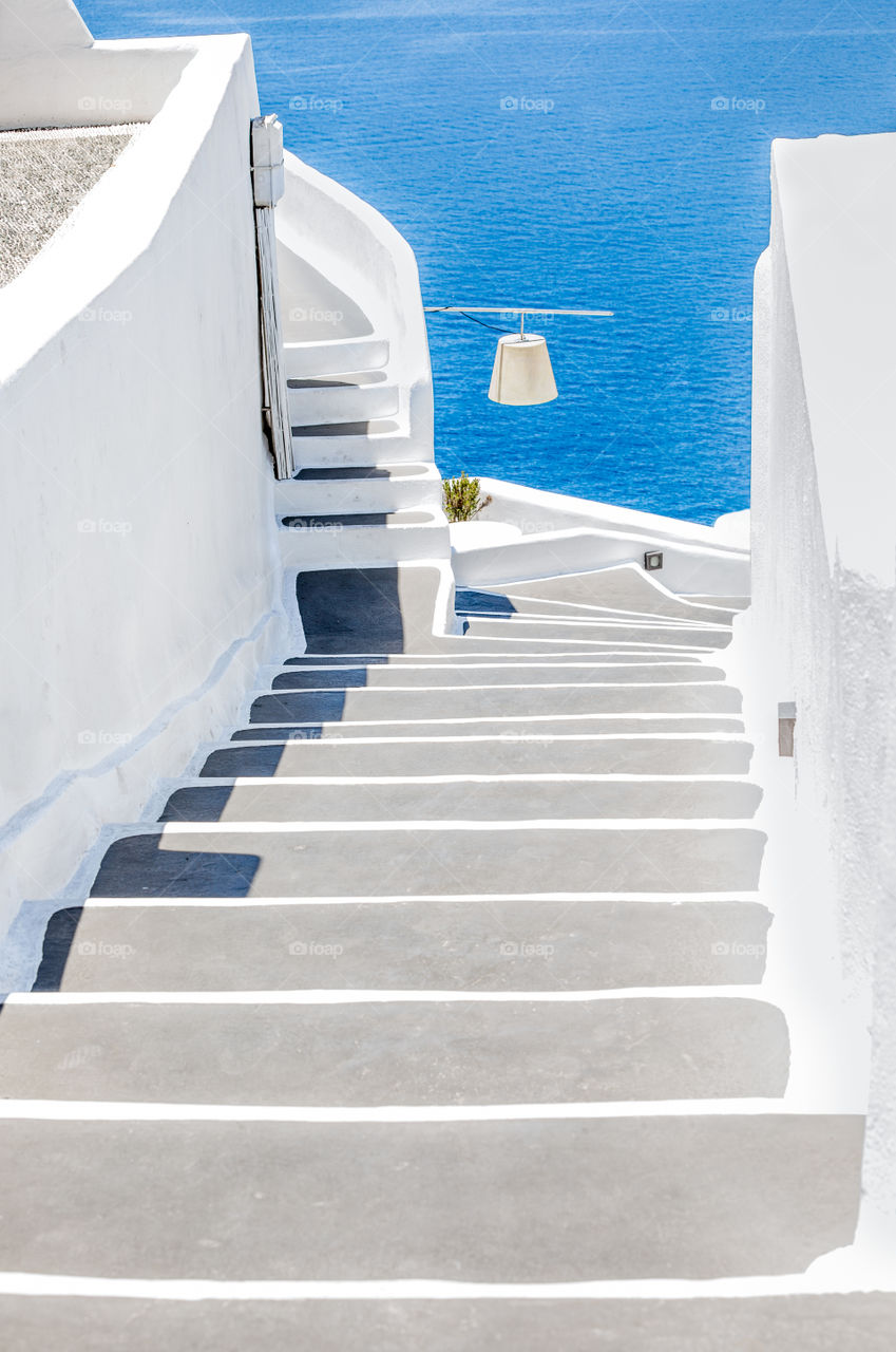 White Stairs Into The Blue Sea On Famous Greek Island Santorini