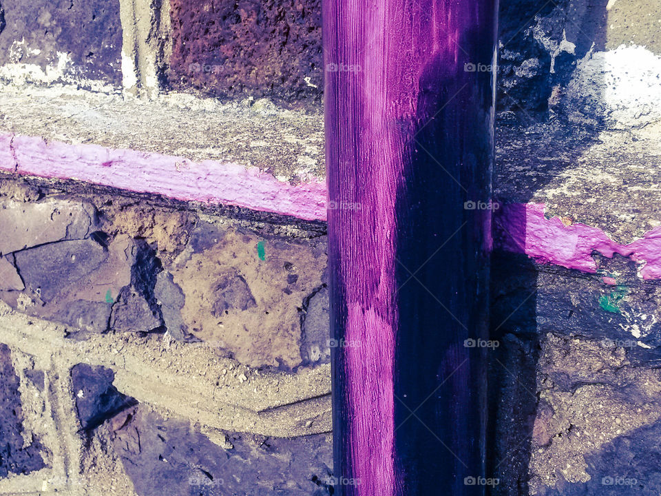 Full frame of stone wall and purple wood