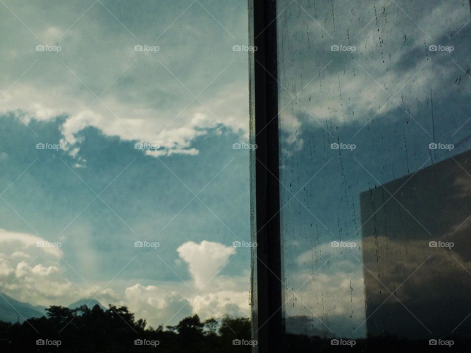 Reflection of clouds on a bright day at the window glass...