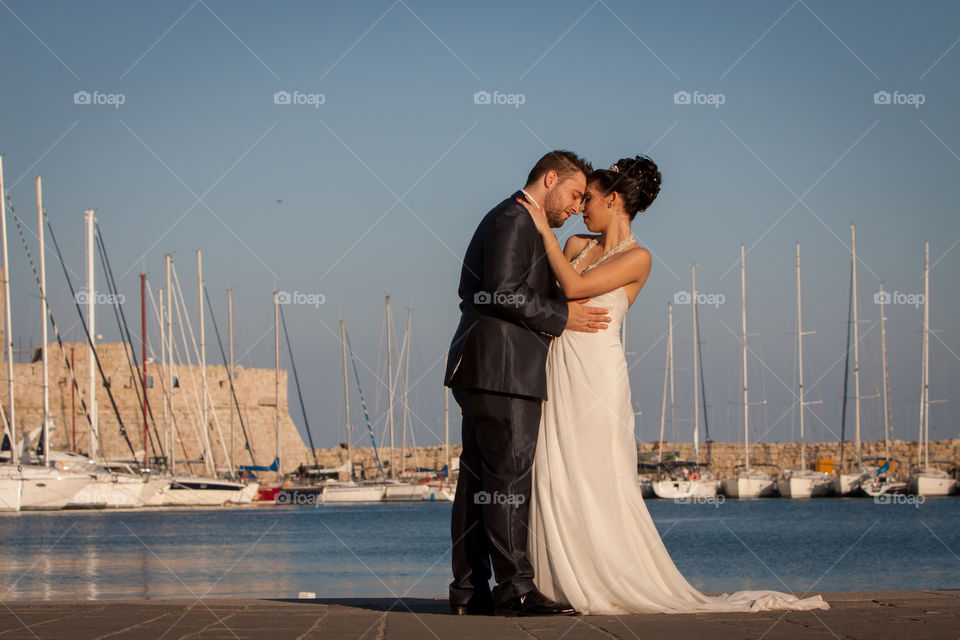 Married couple embracing at harbor