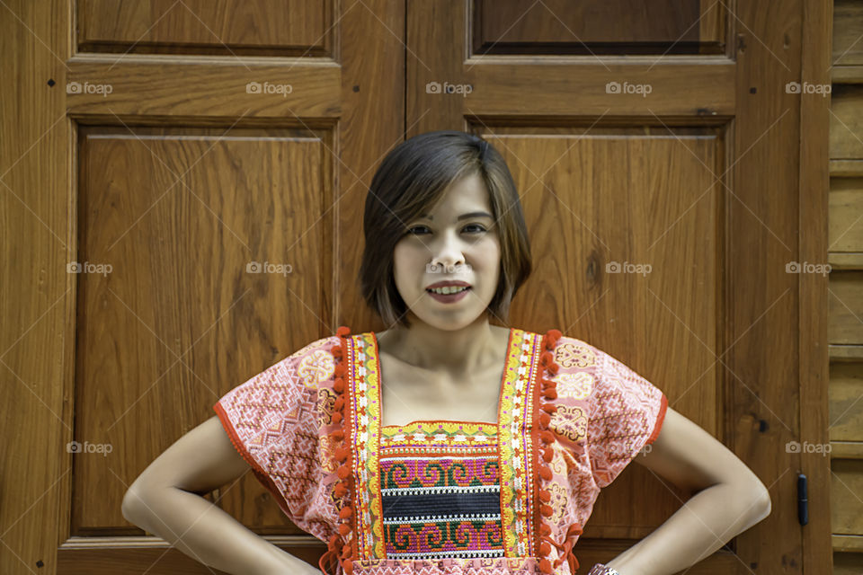 Portrait of Asean woman wearing a native of northern Thailand  background wooden wall.