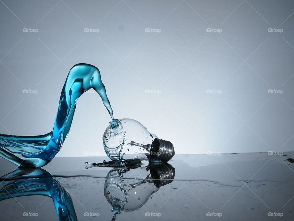 Close-up of water splashing against bulb