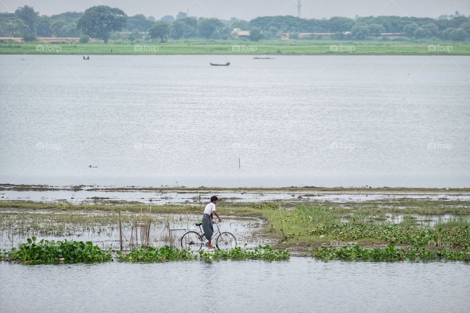 Local life style of fisherman in Early morning at Uben bridge , the longest wooden bridge in the world.