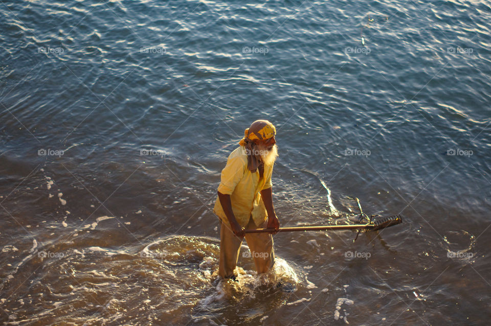 Looking for something, woozy man rake the sea