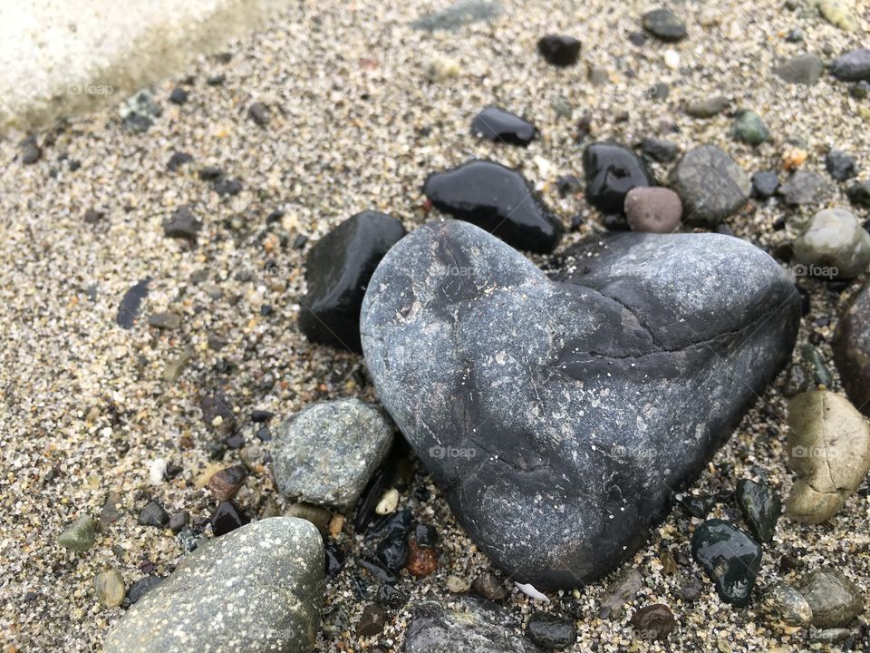 Heart shaped rock on a beach