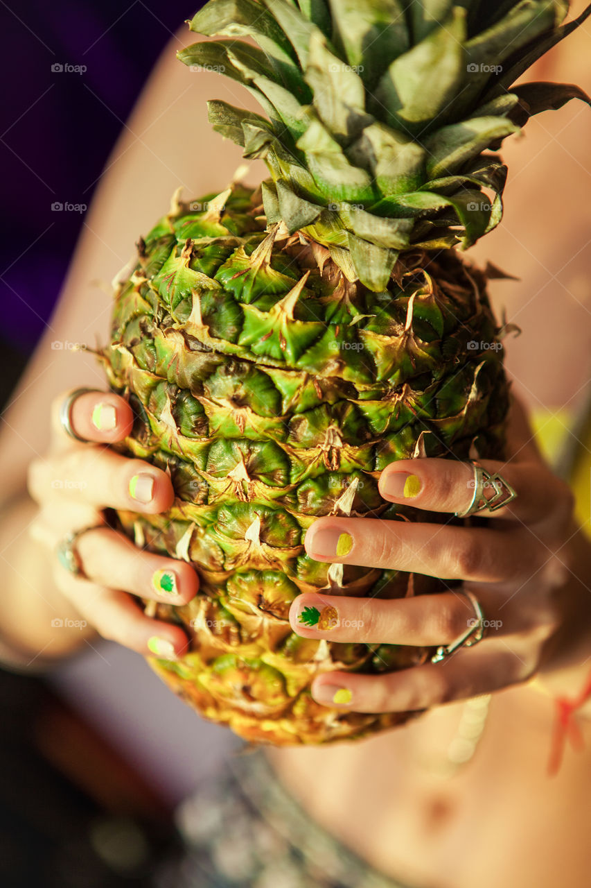 Pineapple in hands 