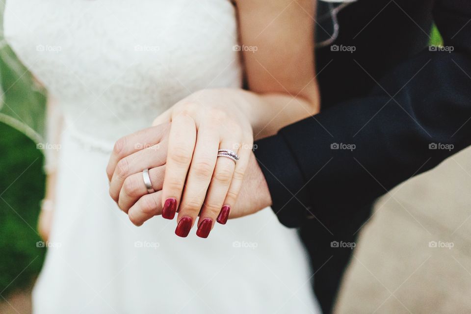 Bride and groom holding hands, just married