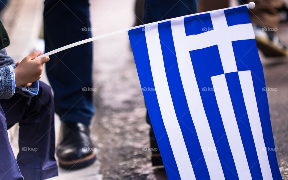 boy holding geek national flag closeup