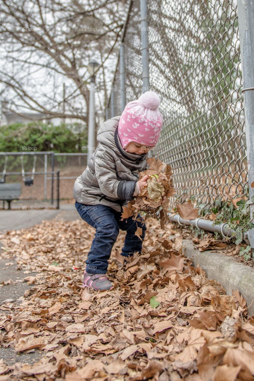 Girl holding dry leaves in hand