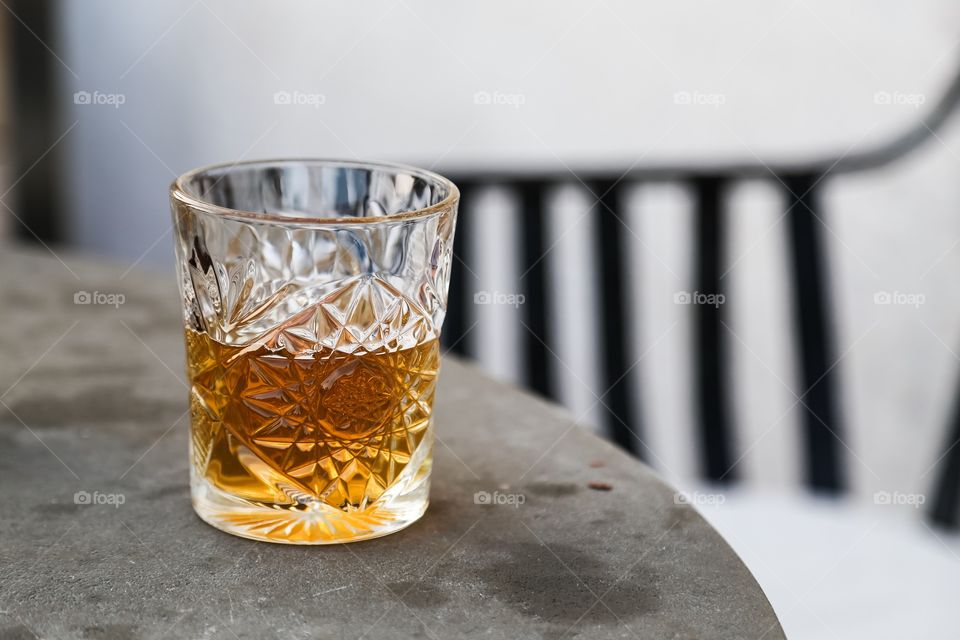 Beautiful drinking glass with drink standing on a table outdoors