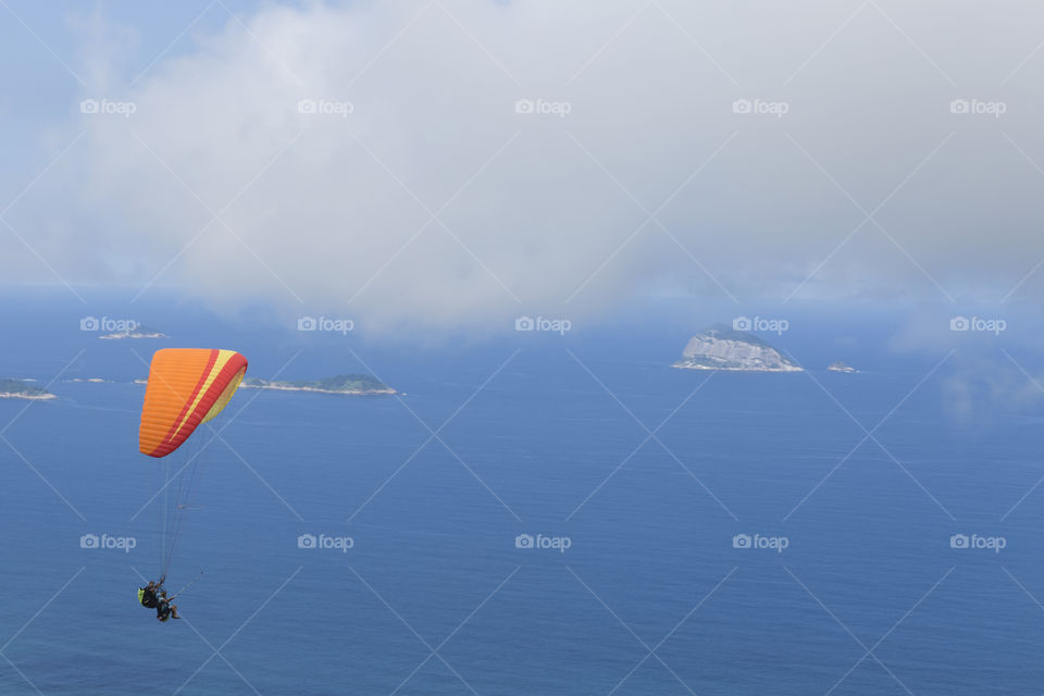 Paraglider flying over Sao Conrrado in Rio de Janeiro Brazil.