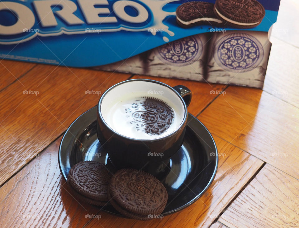 Oreo cookies with cup of milk.