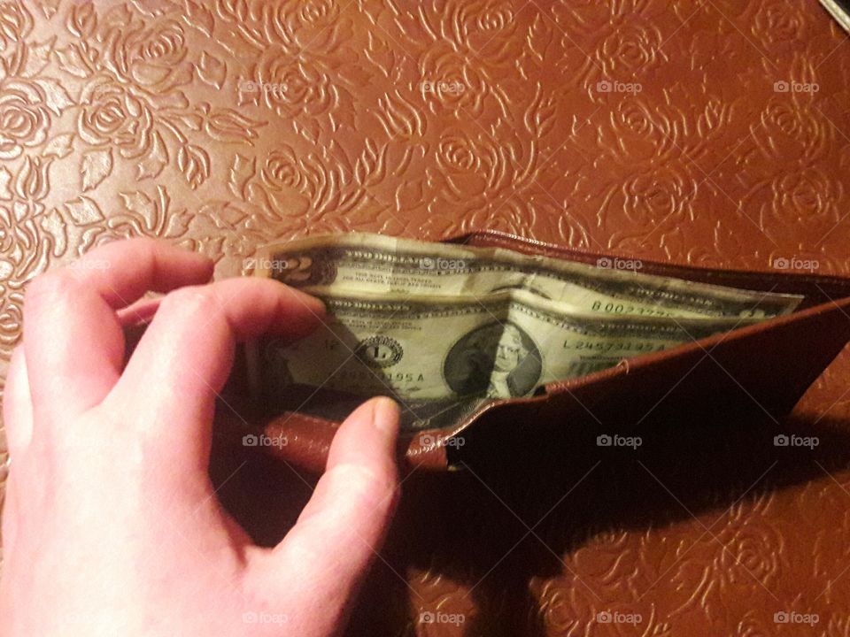 A  set of 2 $2 bills inside of a wallet