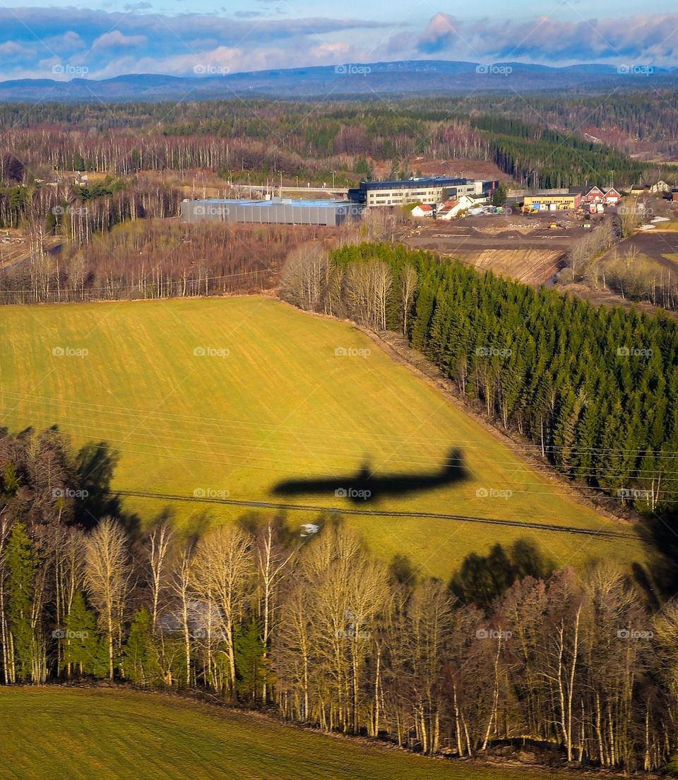 Autumn landscape from the airplane .
You can see the fight shadows at the yellow grund. From the airplane