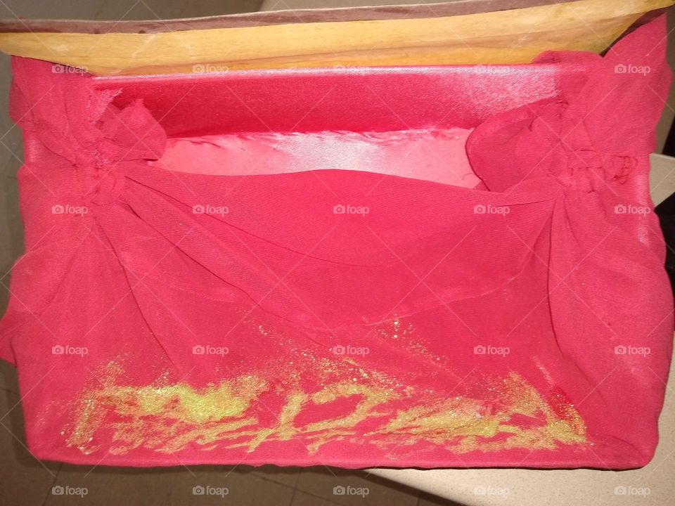 Red draped art piece that is rectangular shaped