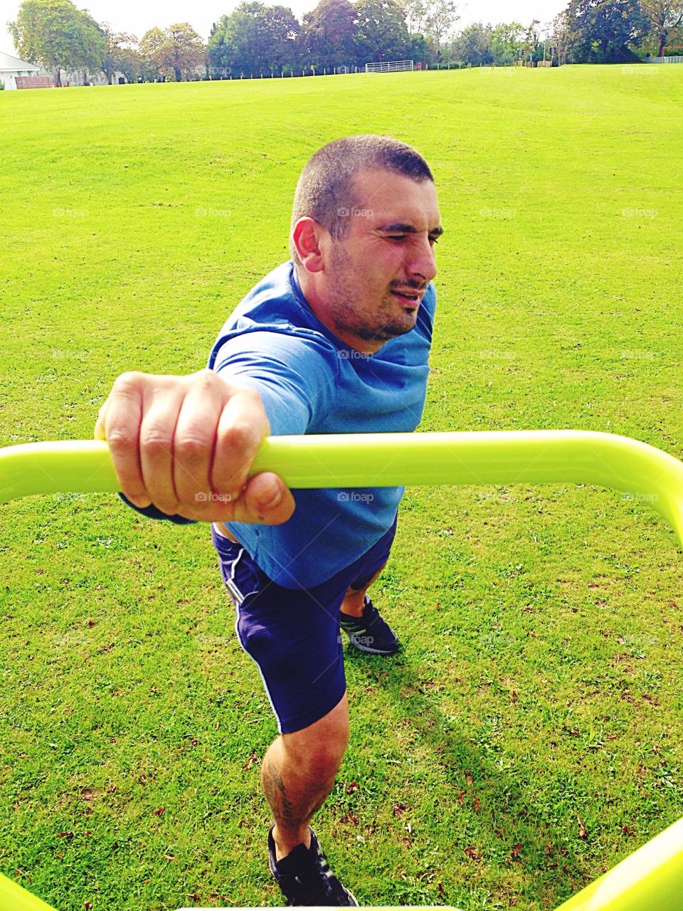 man pulling stupid face whilst exercising