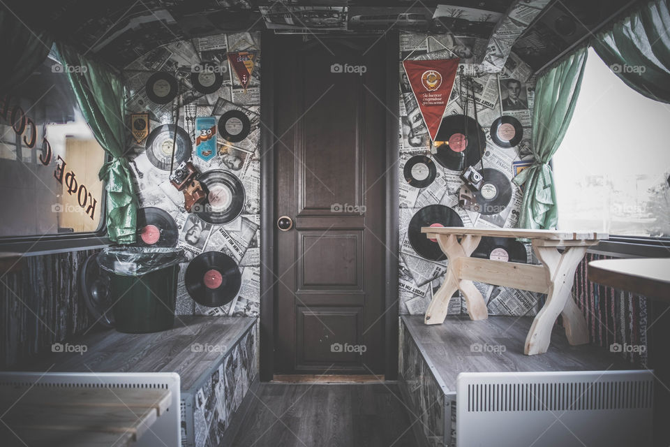 Old vinyls, newspapers and camera on the wall