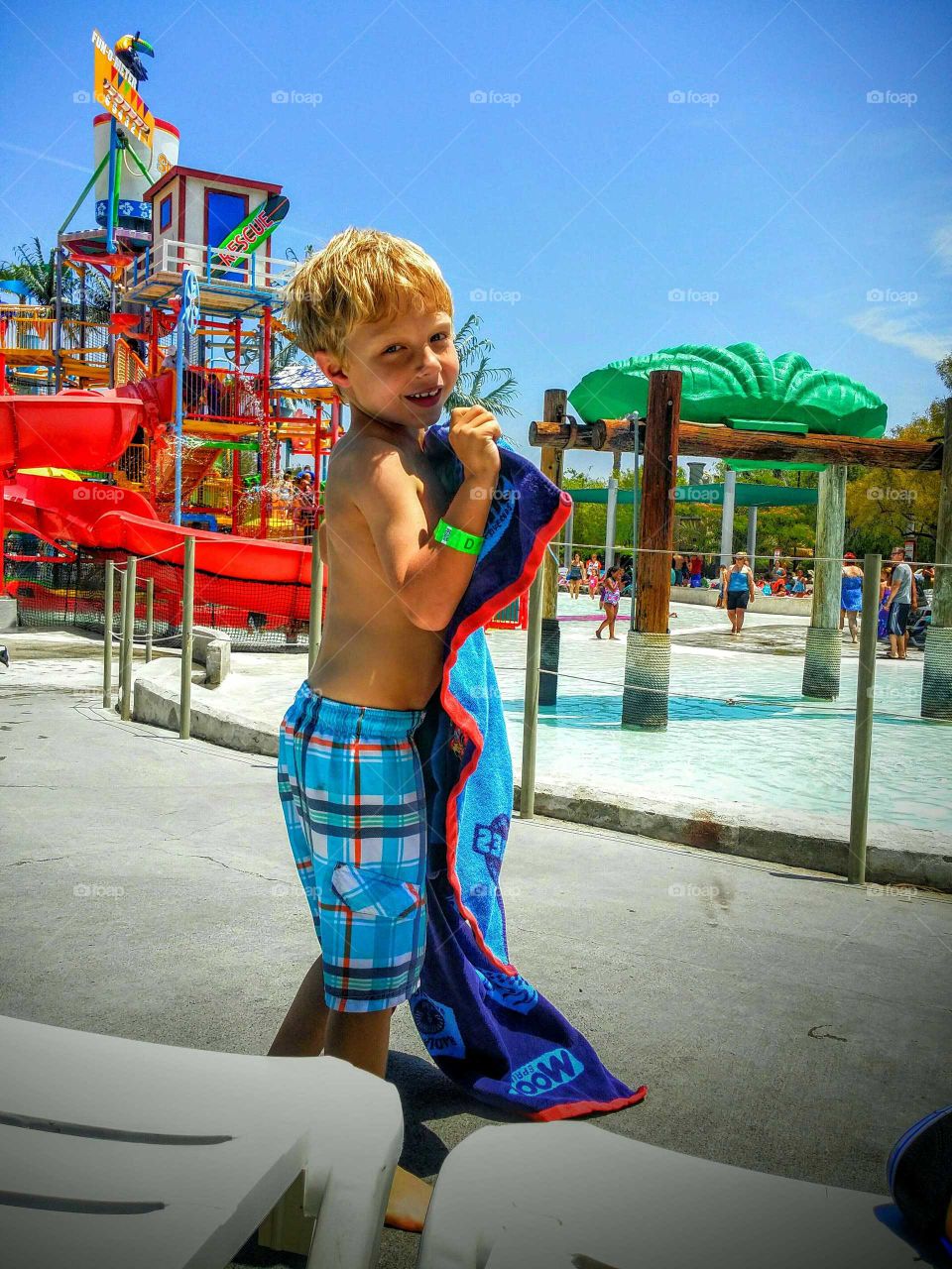 Boy standing near pool
