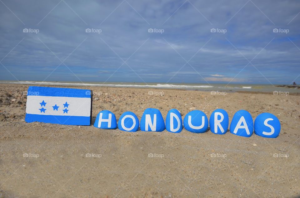 Flag and country name of Honduras painted on stones