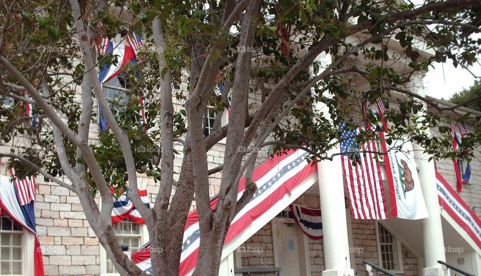 red, white, and blue decorations on Colton Hall in Monterey, California for annual 4th of July celebration