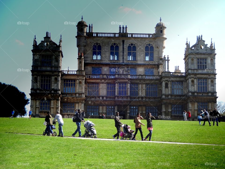 castle  in Wollaton Park. people enjoy spring to walk in front of the batman castle 