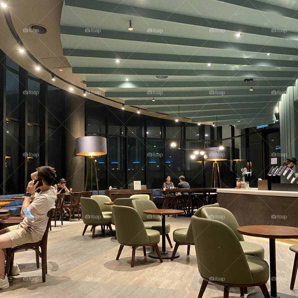 This cafe with that classically cool look, Curvilinear concrete walls, plenty of wood accents, and modern furniture all nestled into a minimalist space.