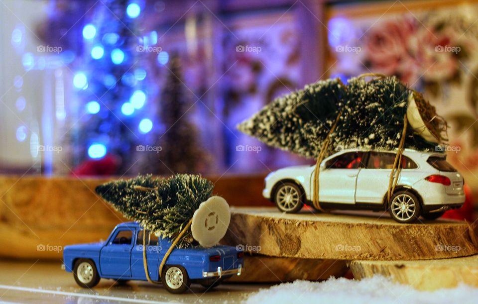 Small blue and white car with Christmas tree 