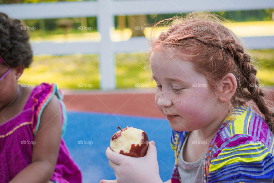 Young Girl Eating an Apple at the Park 4