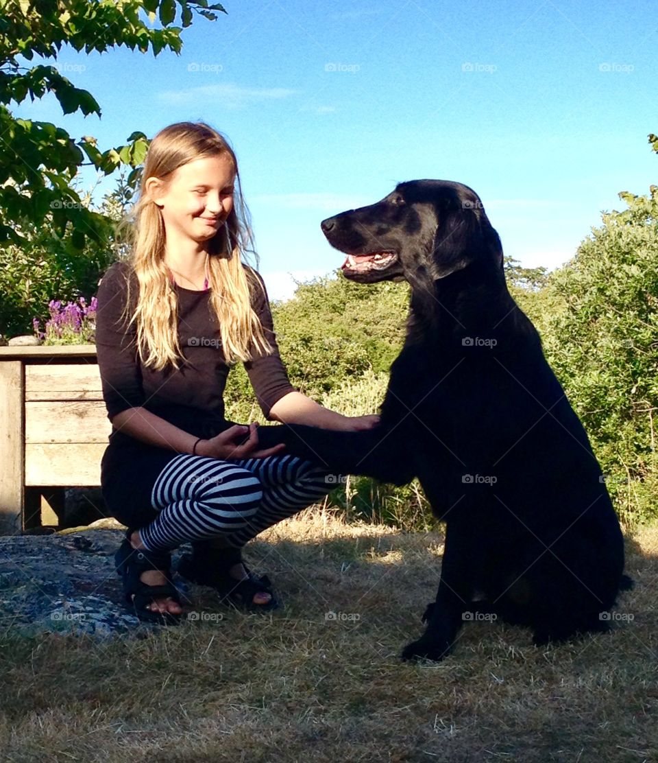 Teenage girl holding dog