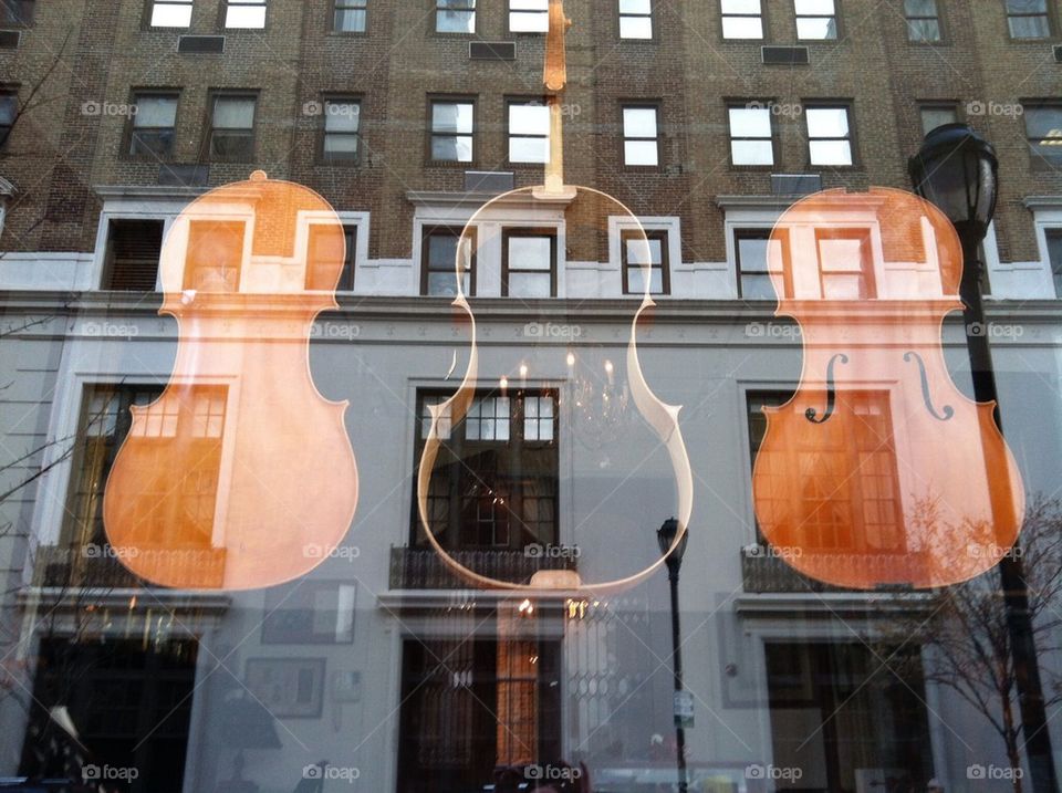 Violin store with city reflection