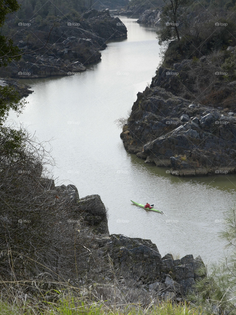 A person kayaking on river