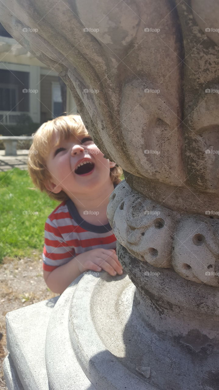 Close-up of a cute boy near sculpture