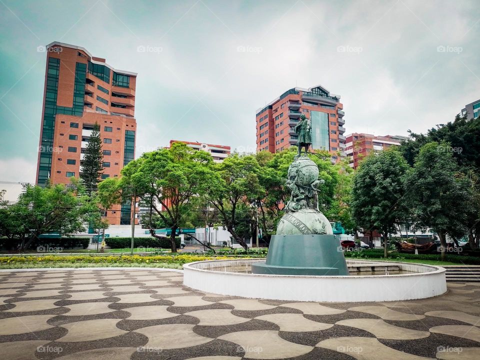 Monument to Christopher Columbus in Guatemala City, with a beautiful view of the buildings and trees that adorn it