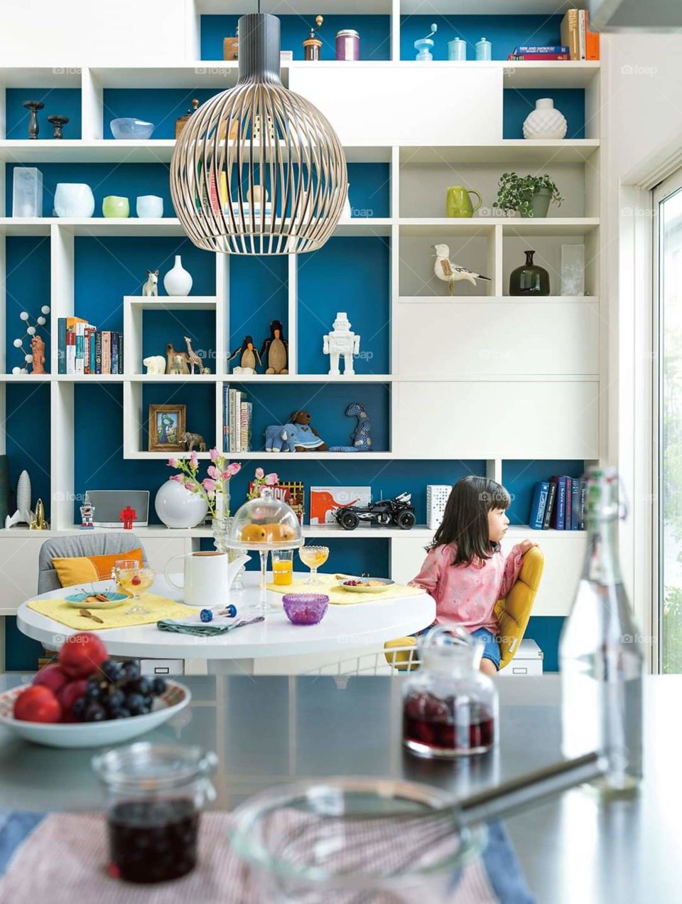 a little girl sitting and looking outside the window