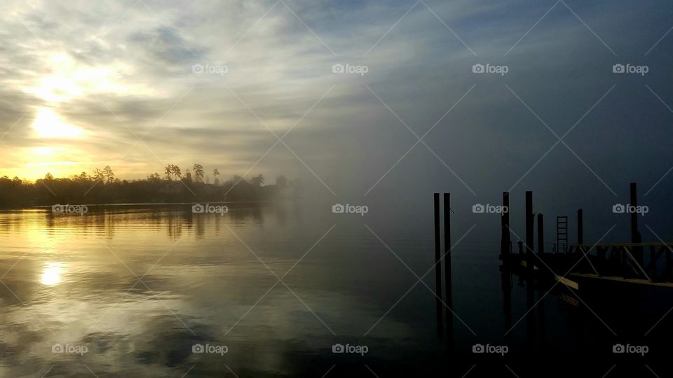 sunrise and the receeding fog on the lake.