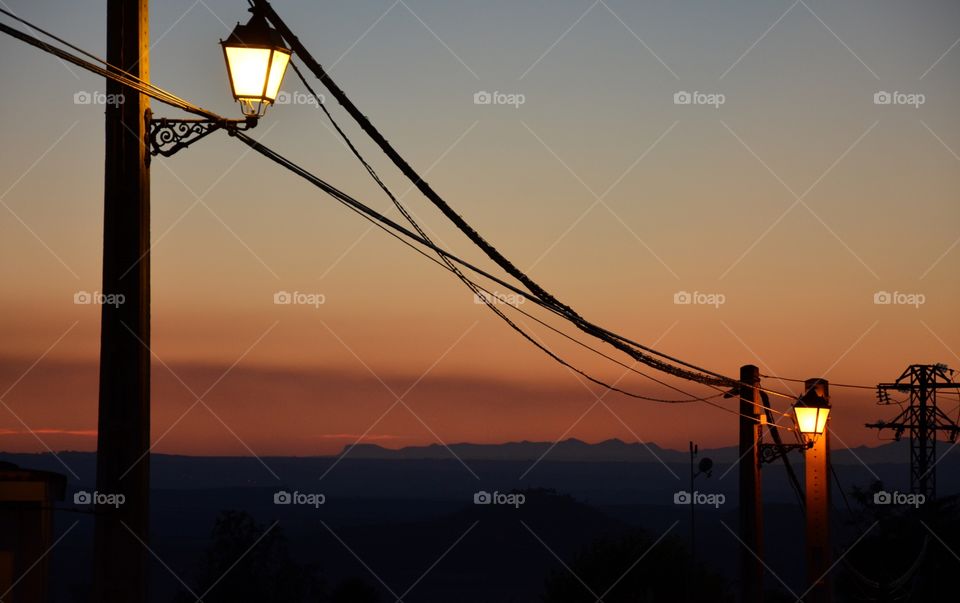 two streetlights during a beautiful sunset