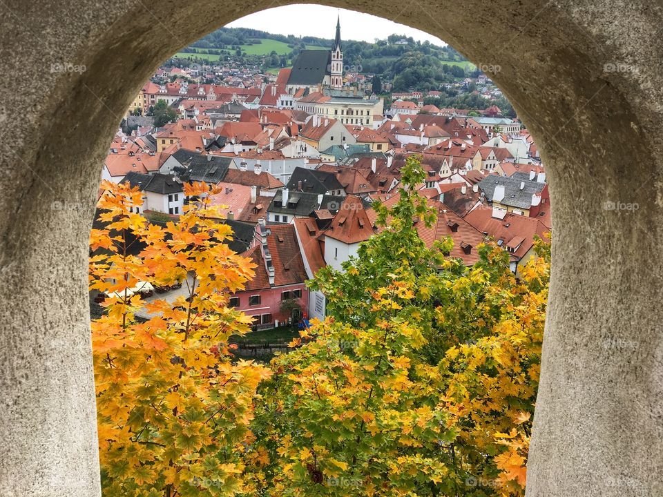 A glimpse through an arched window of the golden leaves looking down over  Cesky Krumlov ... Autumn is coming ... 