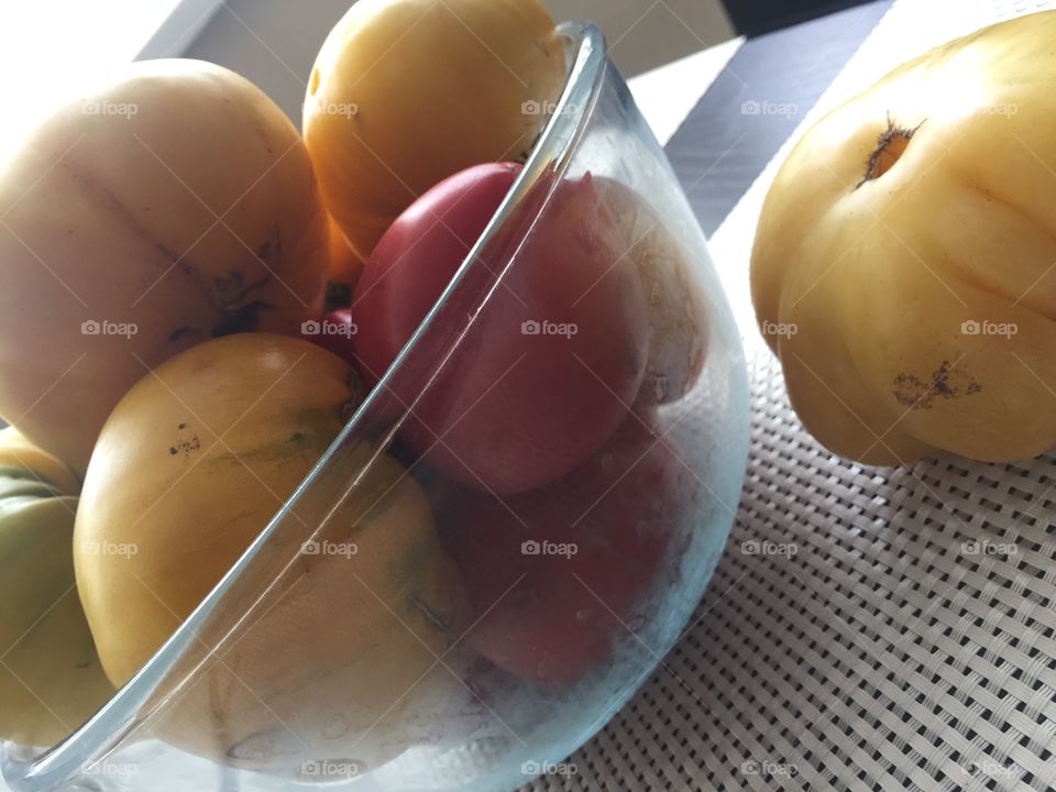 Tomatoes in a glass bowl on the table