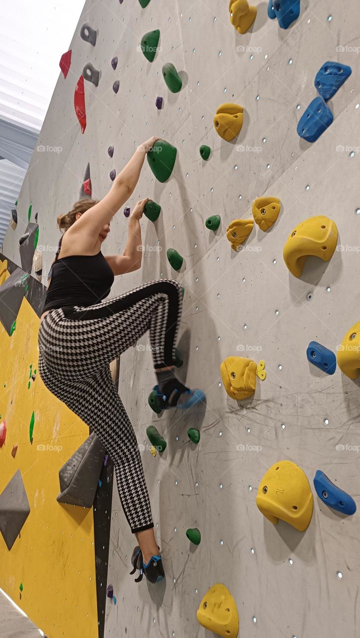 young woman who does indoor climbing