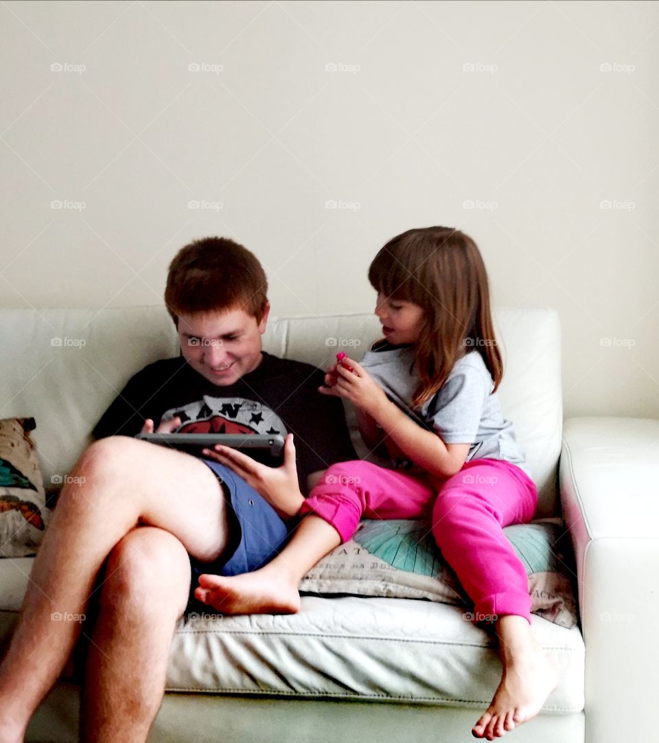 Brother and sister watching on tablet