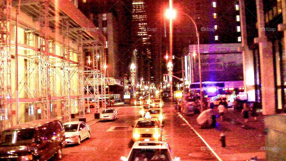 Cars on a busy street in Manhattan in New York City at night