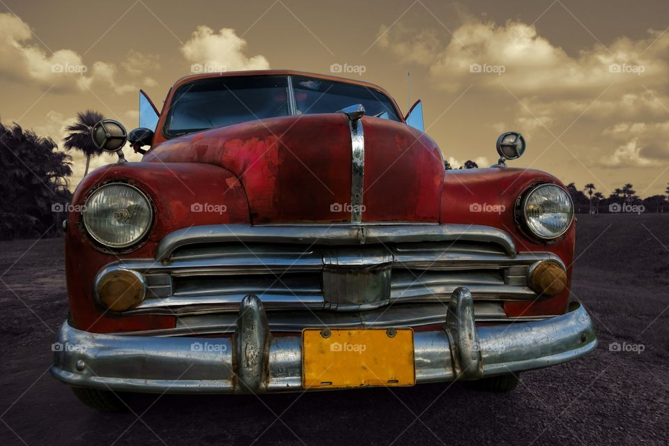 Classic American car in Cuba. A beautiful old Cuban car on a parking lot nearby Vinales, Cuba in tropical setting.