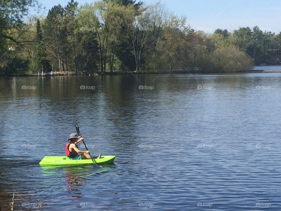 Calm waters. 9-year-old paddling kayak