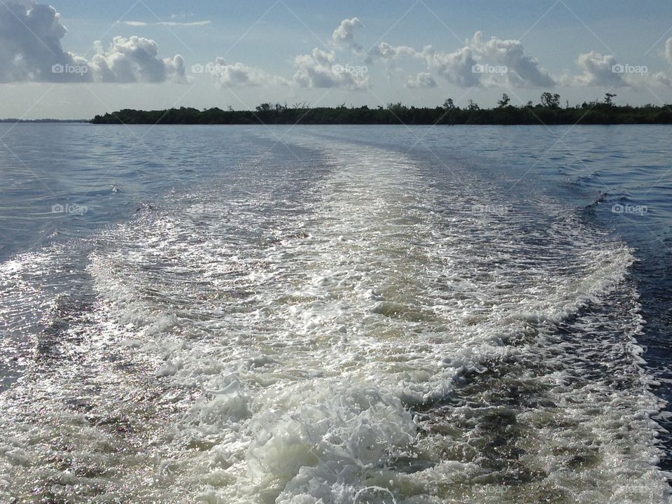Wake of water from the boat in the ocean.