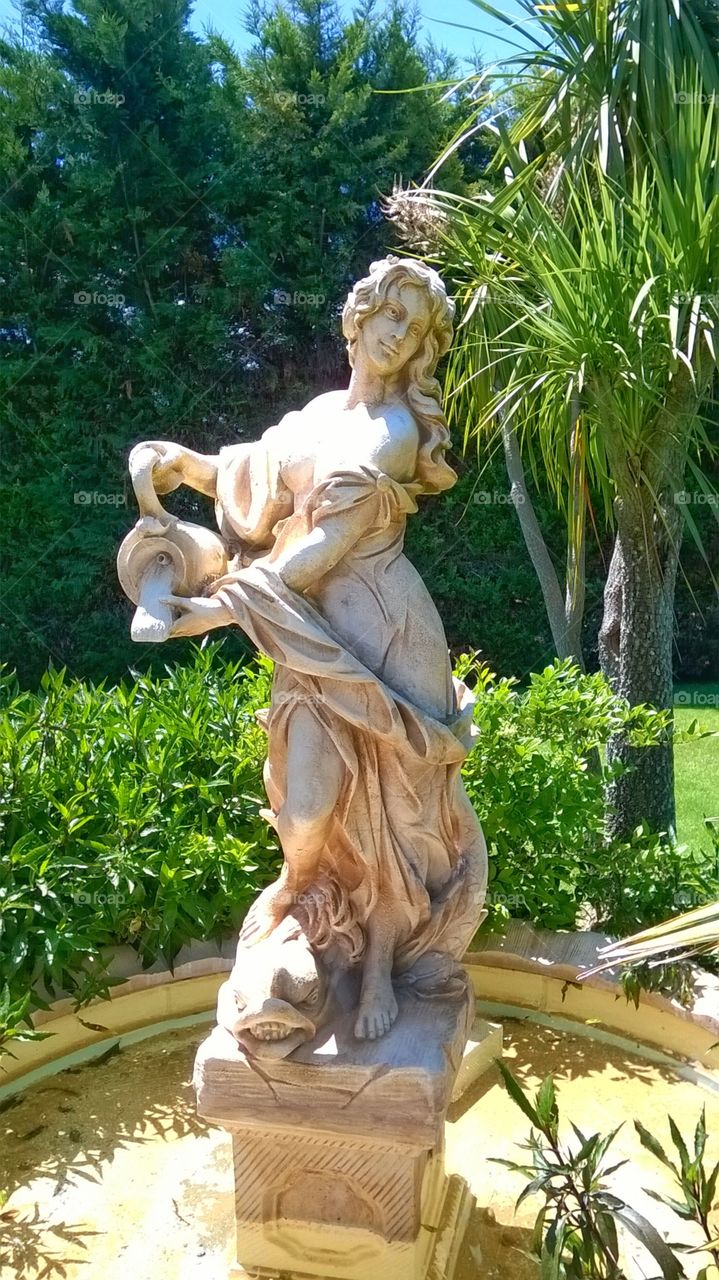 woman statue with bottle